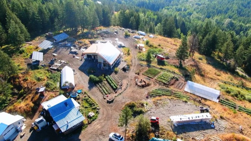 A working homestead with greenhouses and garden beds